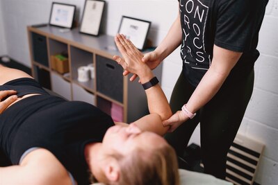 Chiropractor assessing a patient in a modern chiropractic clinic